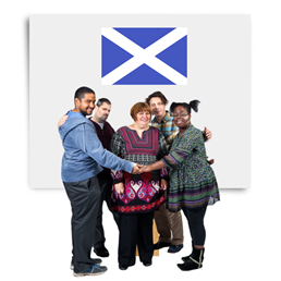People in a circle around a woman protecting her underneath a Scotland flag.